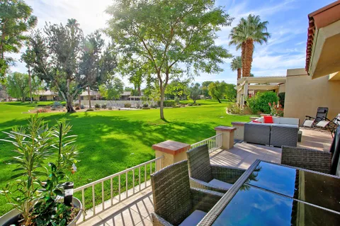 a view of a garden with an outdoor seating