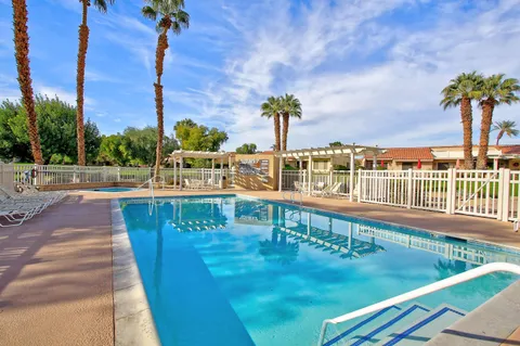 a view of a swimming pool with a lounge chair