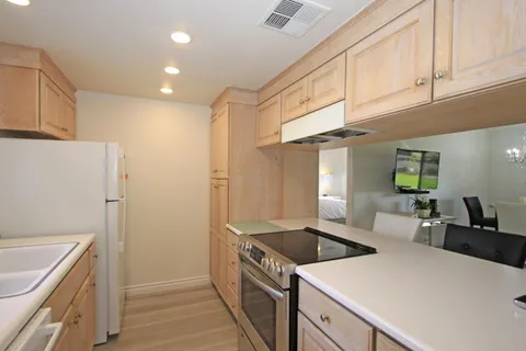 a kitchen with a stove and a refrigerator