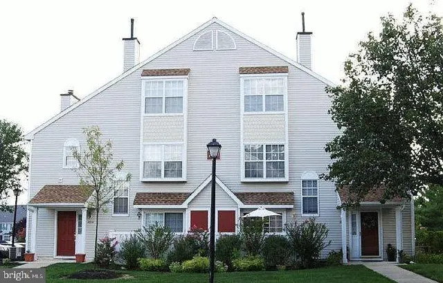 a view of a brick building next to a yard