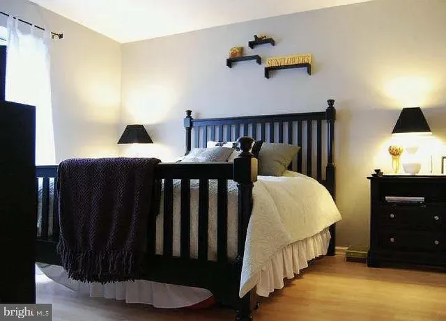 a bedroom with a bed and a night stand