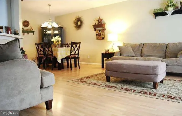 a living room with furniture and a dining table