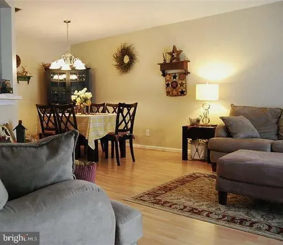 a living room with furniture and a chandelier