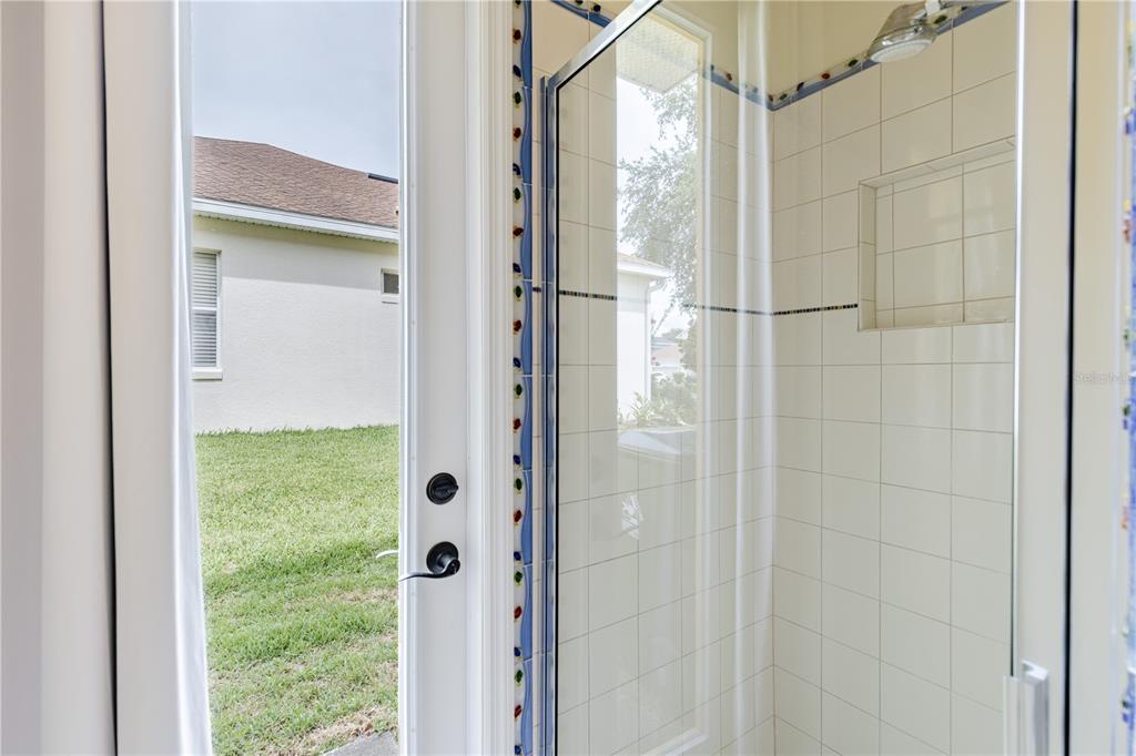 2718 Knightsbridge Road Clermont, FL 34711 - Photo 26 of 72 a bathroom with a glass shower door
