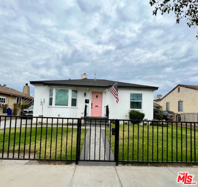2485 Leo Avenue Commerce, CA 90040 - Photo 1 of 1 a front view of a house with a garden