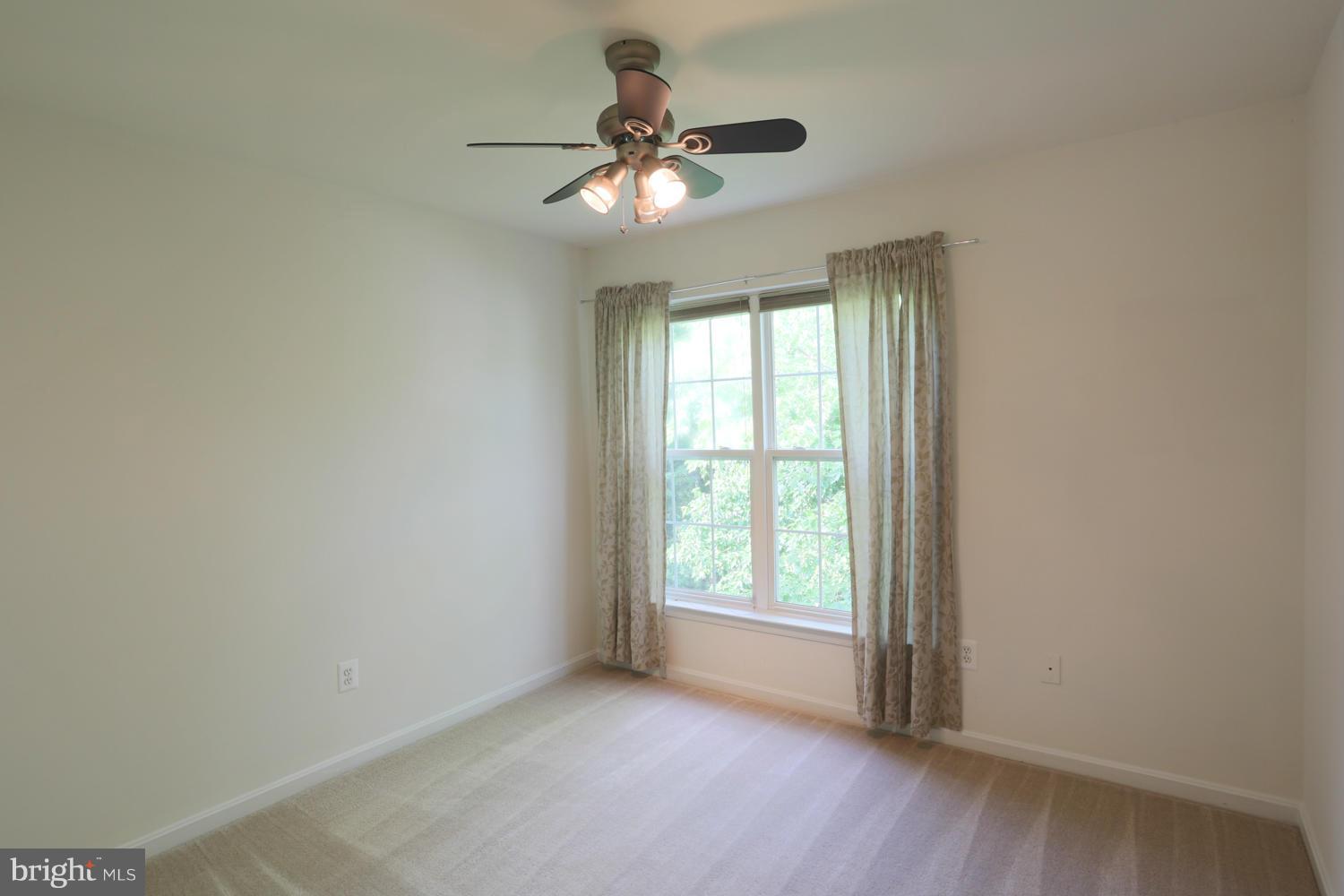 1518 Ringe Drive Severn, MD 21144 - Photo 13 of 30 an empty room with a window and a fan