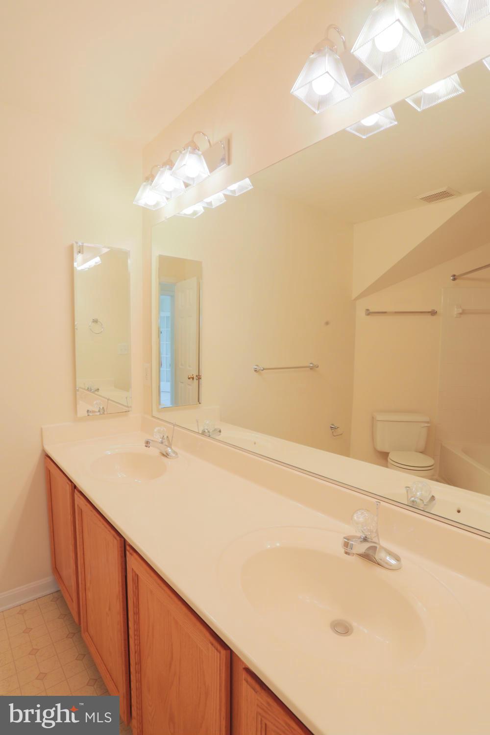 1518 Ringe Drive Severn, MD 21144 - Photo 18 of 30 a bathroom with a sink and a mirror