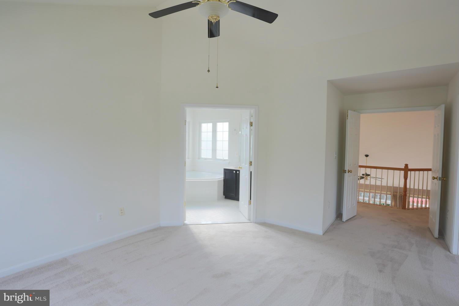 1518 Ringe Drive Severn, MD 21144 - Photo 20 of 30 an empty room with chandelier fan and windows