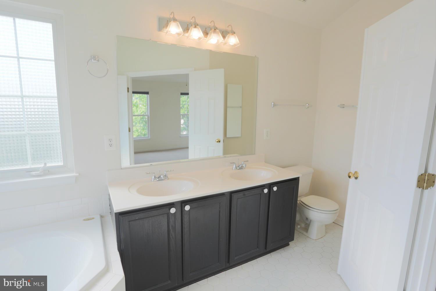 1518 Ringe Drive Severn, MD 21144 - Photo 21 of 30 a bathroom with a sink and a mirror