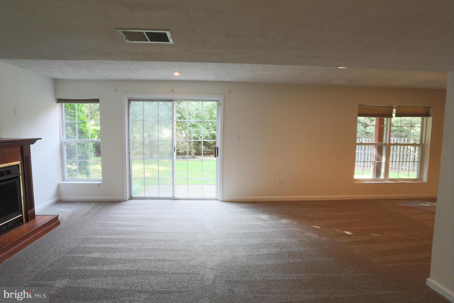 1518 Ringe Drive Severn, MD 21144 - Photo 23 of 30 a view of an empty room with a fireplace and a window