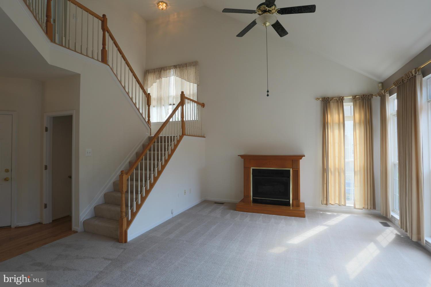 1518 Ringe Drive Severn, MD 21144 - Photo 5 of 30 a view of a livingroom with a fireplace stairs and windows