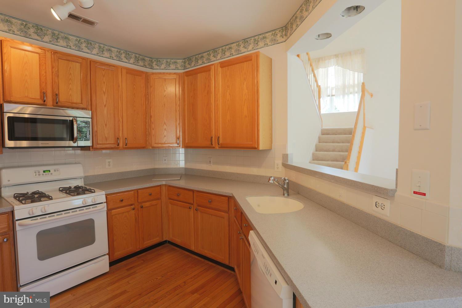1518 Ringe Drive Severn, MD 21144 - Photo 8 of 30 a kitchen with a sink a stove and cabinets