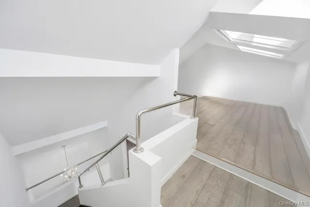 a view of a hallway with wooden floor and entryway