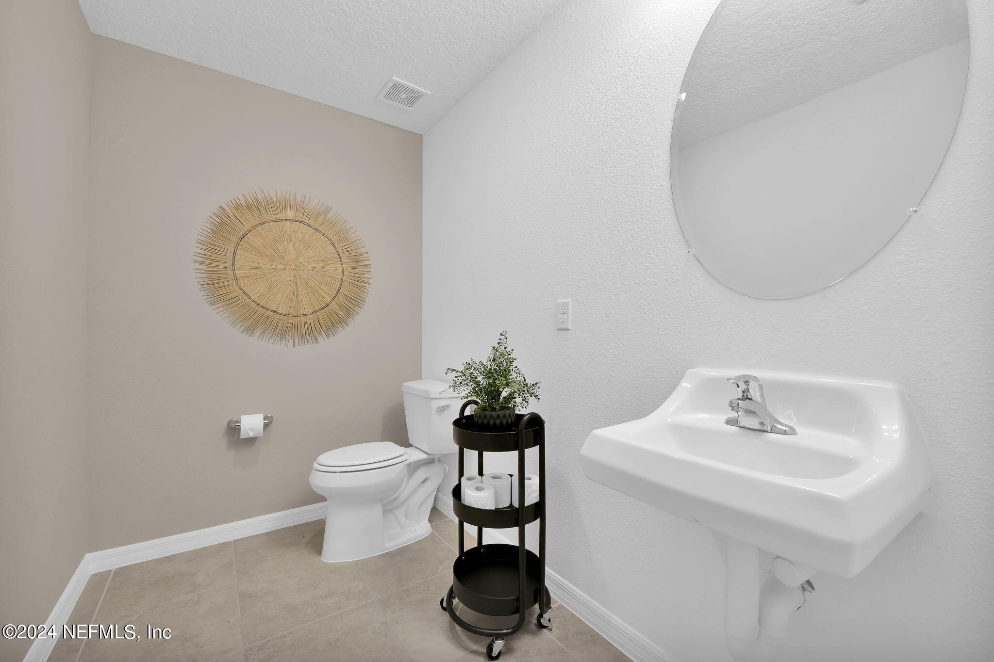 5460 Integrity Way Jacksonville, FL 32244 - Photo 13 of 31 a bathroom with a toilet a sink and a mirror