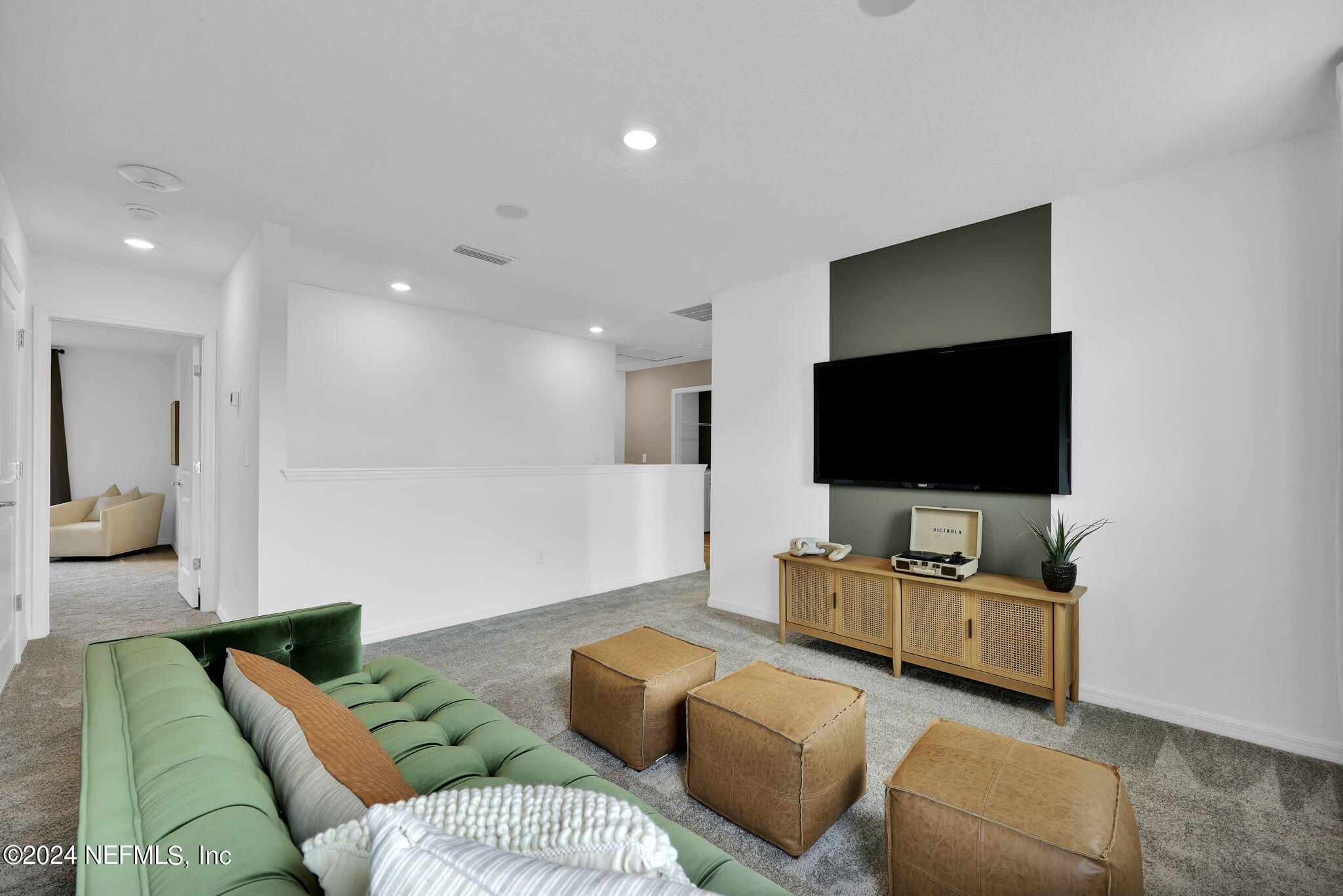 5460 Integrity Way Jacksonville, FL 32244 - Photo 16 of 31 a living room with furniture and a flat screen tv