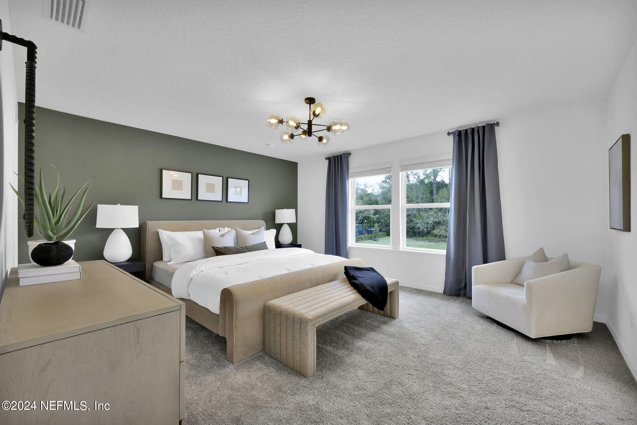 5460 Integrity Way Jacksonville, FL 32244 - Photo 17 of 31 a spacious bedroom with a bed and a couch