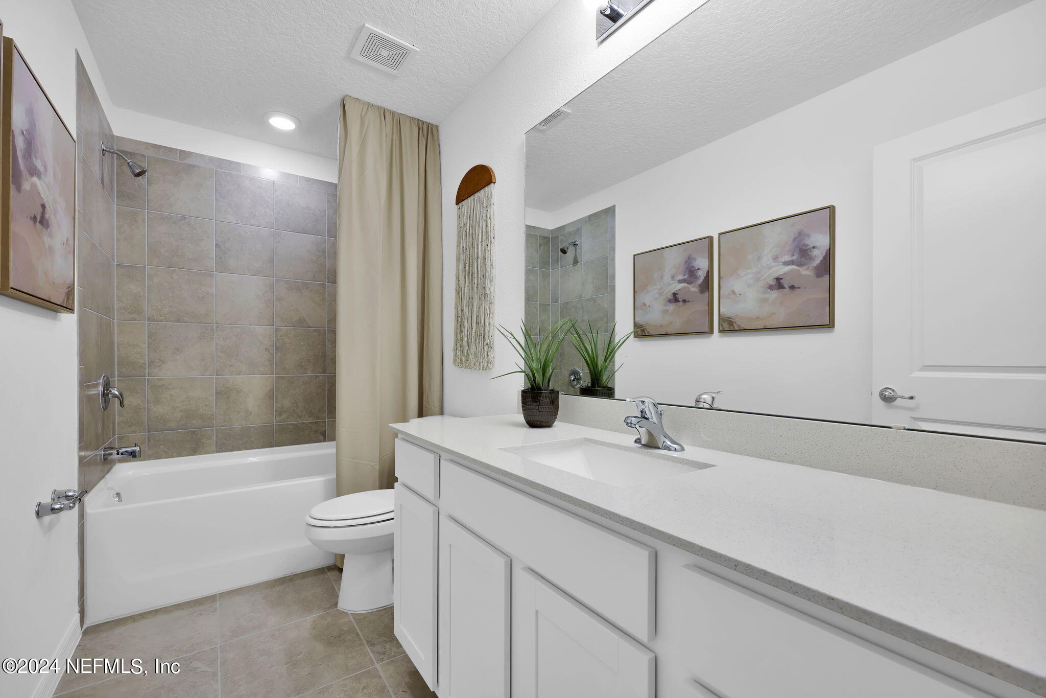 5460 Integrity Way Jacksonville, FL 32244 - Photo 22 of 31 a bathroom with a bathtub shower sink vanity mirror and toilet