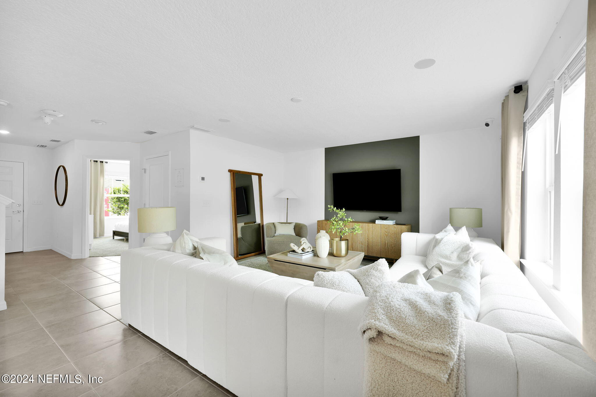 5460 Integrity Way Jacksonville, FL 32244 - Photo 7 of 31 a living room with furniture and a flat screen tv