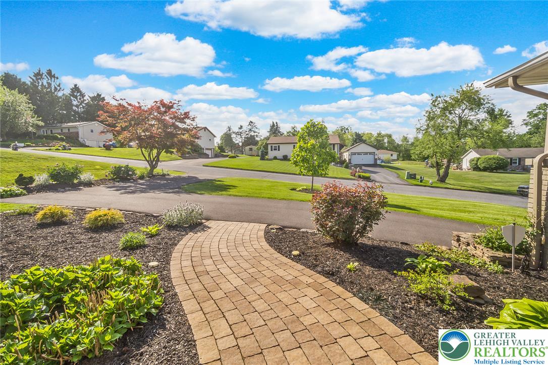 540 Briar Road Pen Argyl, PA 18072 - Photo 2 of 66 brick pathway leads to a peaceful neighborhood with manicured lawns and mature trees.