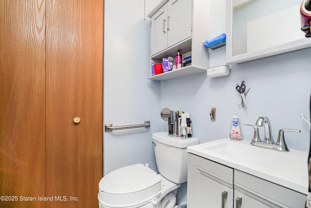a bathroom with a sink a toilet and vanity