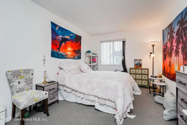 a bedroom with a bed and a television