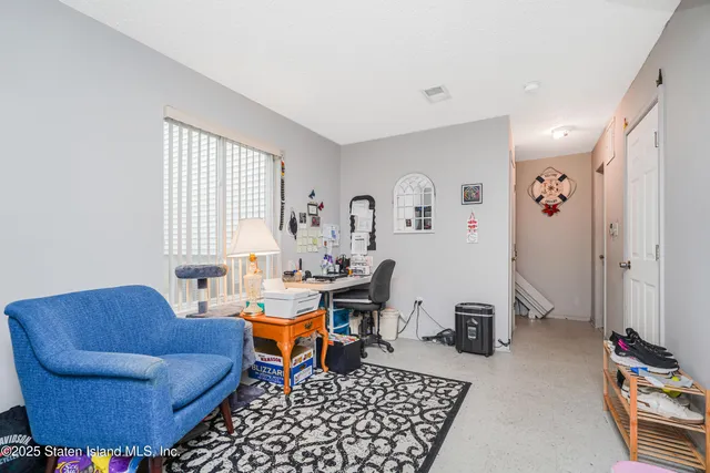 a living room with furniture a rug and a window