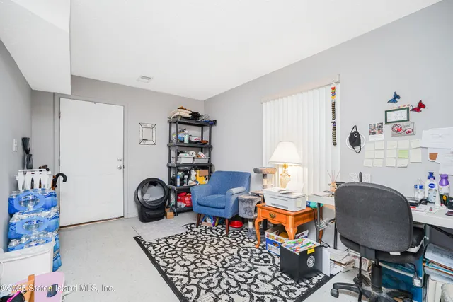 a bedroom with furniture and a fan