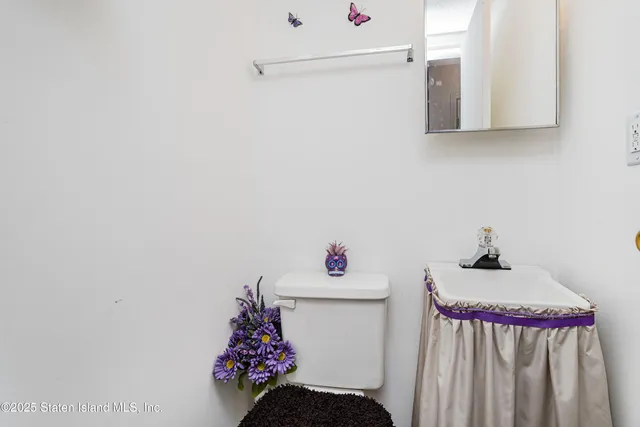 a white cabinet sitting in a bathroom