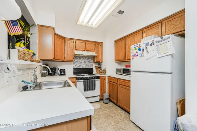 a kitchen with stainless steel appliances a refrigerator sink and microwave