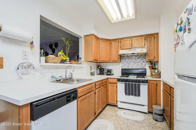 a kitchen with a sink stove and microwave