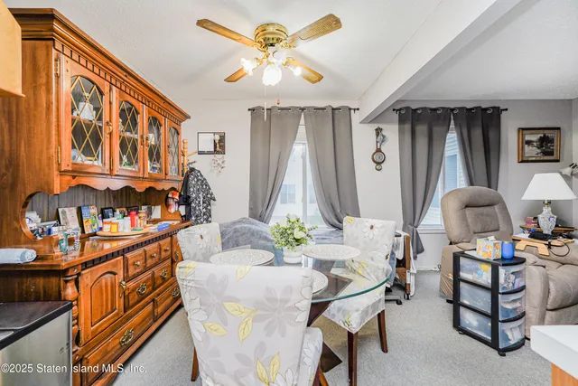 a living room with furniture fireplace and a large window