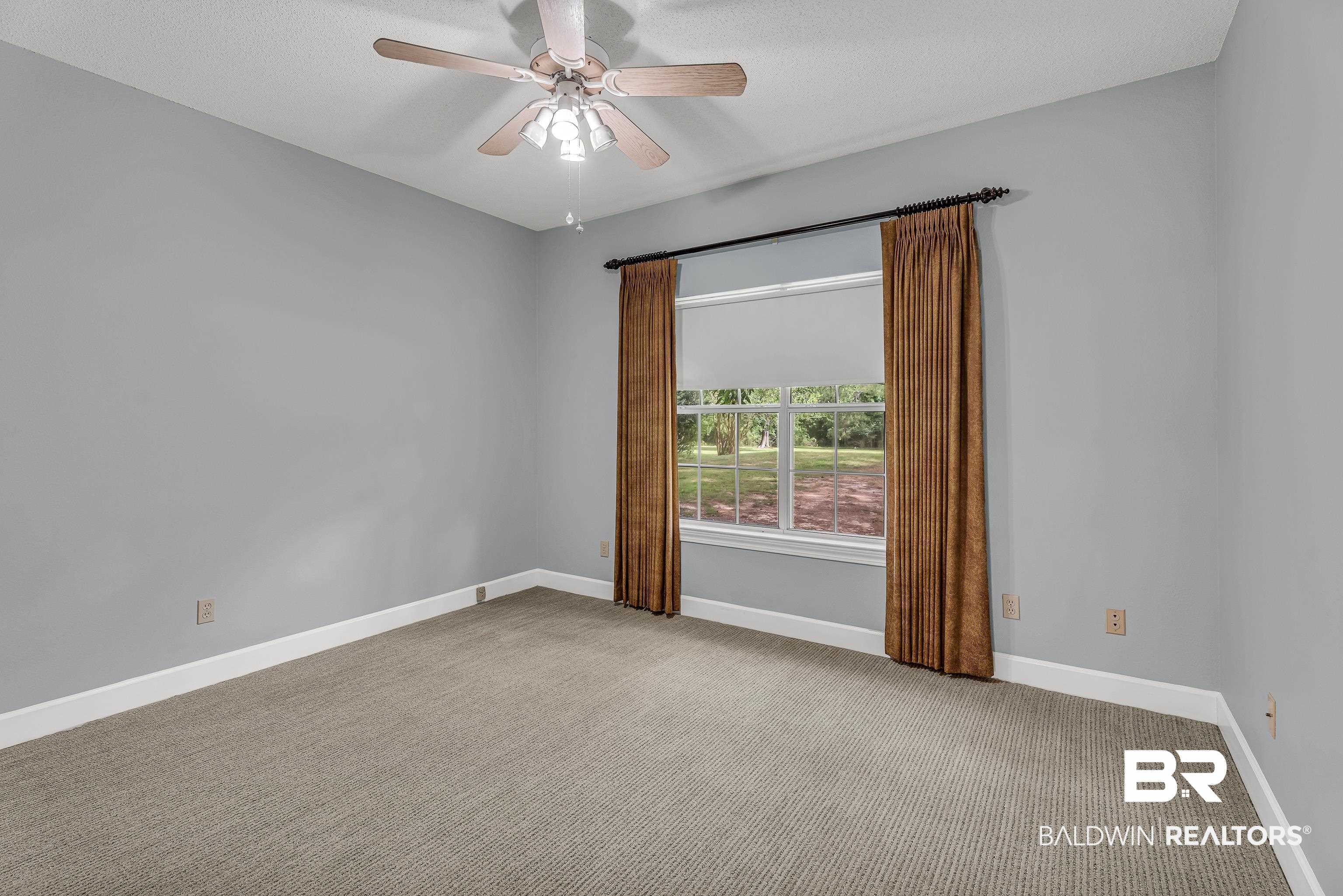 9530 Pilgrim Drive Elberta, AL 36530 - Photo 21 of 61 Carpeted spare room with baseboards, ceiling fan, and a textured ceiling