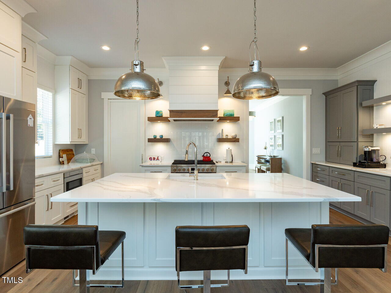 3416 Edgemont Drive Raleigh, NC 27612 - Photo 11 of 49 a kitchen with stainless steel appliances a dining table chairs stove and refrigerator