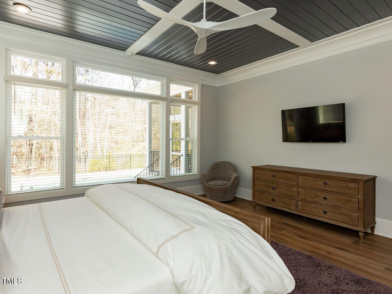 3416 Edgemont Drive Raleigh, NC 27612 - Photo 19 of 49 a bedroom with a bed a flat screen tv and a window