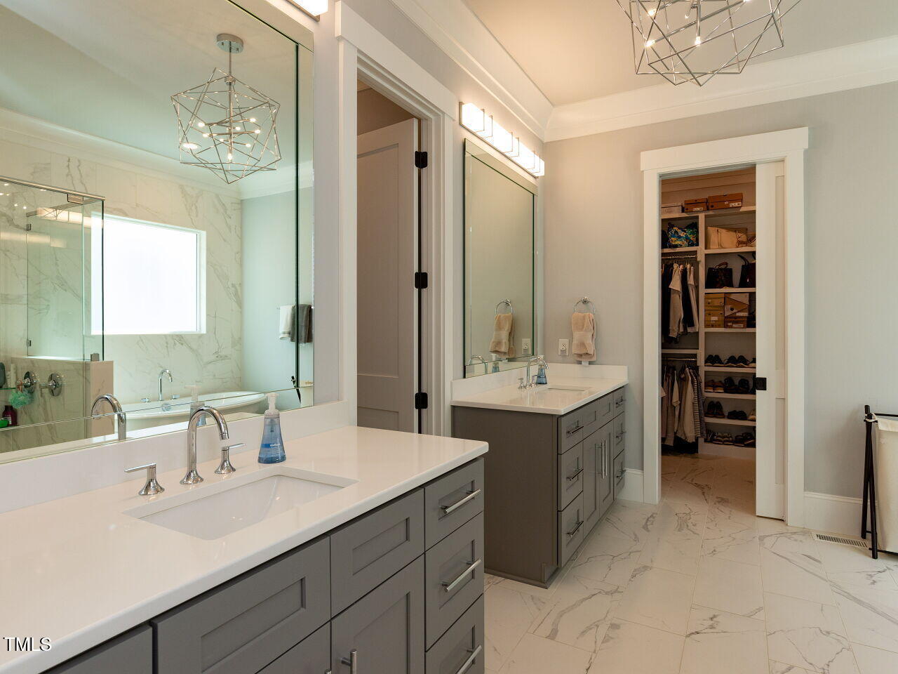 3416 Edgemont Drive Raleigh, NC 27612 - Photo 20 of 49 a spacious bathroom with a double vanity sink a large mirror and a shower