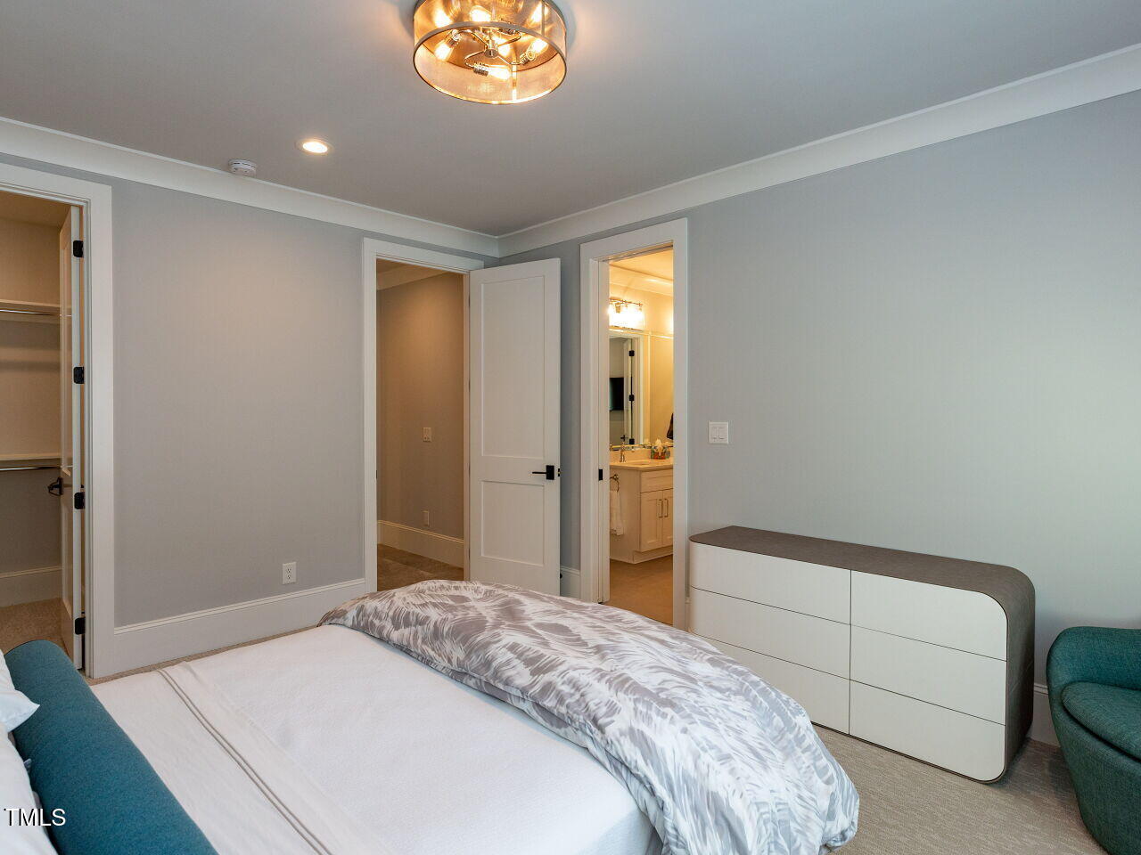 3416 Edgemont Drive Raleigh, NC 27612 - Photo 32 of 49 a bedroom with a bed and a chandelier