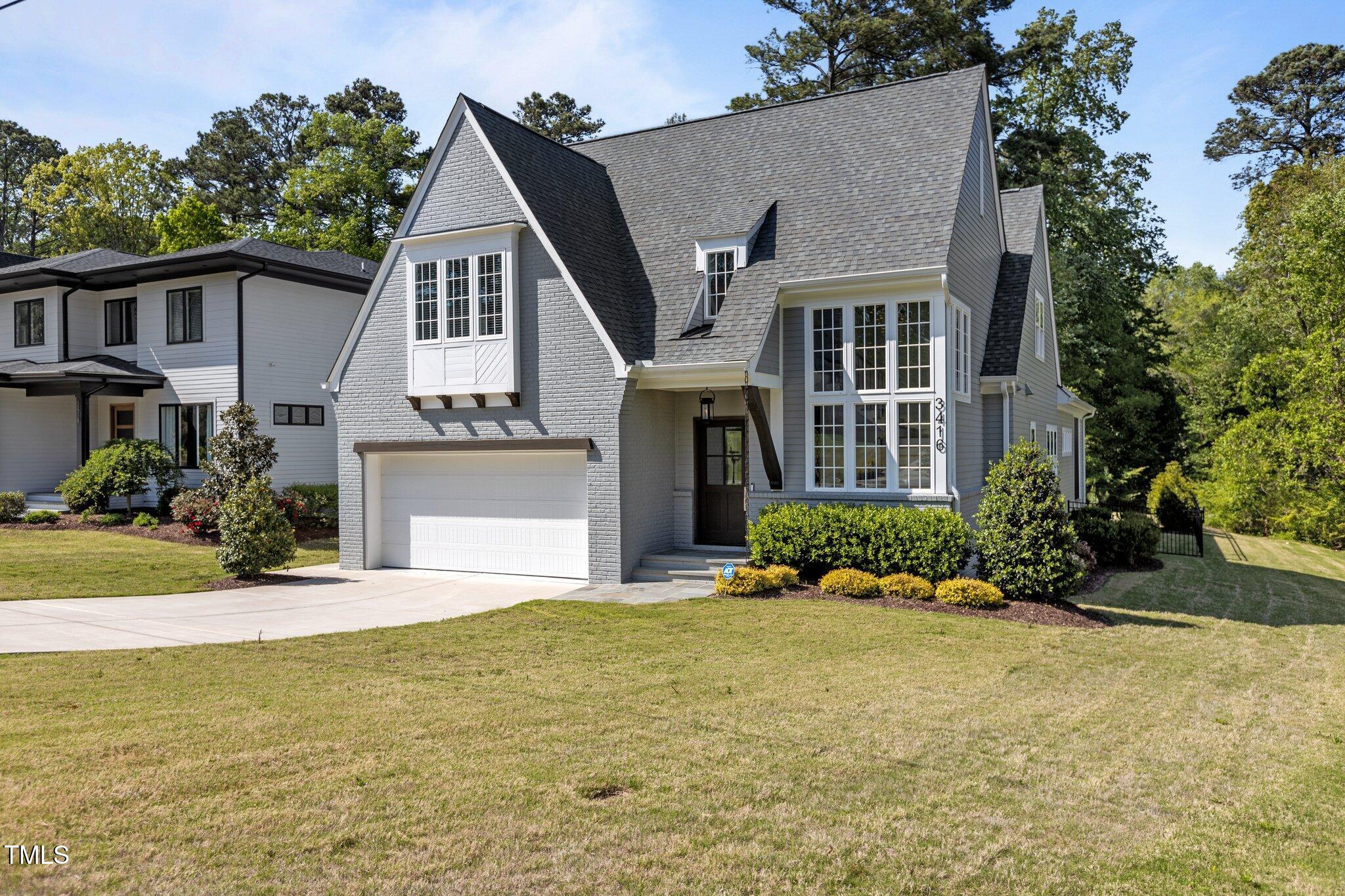 3416 Edgemont Drive Raleigh, NC 27612 - Photo 48 of 49 a front view of a house with a yard and garage