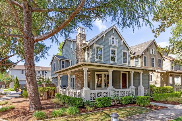 a front view of a house with yard and green space