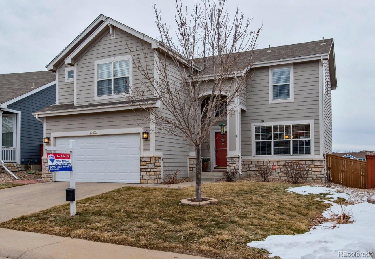 10232 Willowbridge Way Highlands Ranch, CO 80126 - Photo 15 of 33 a front view of a house with a yard and garage