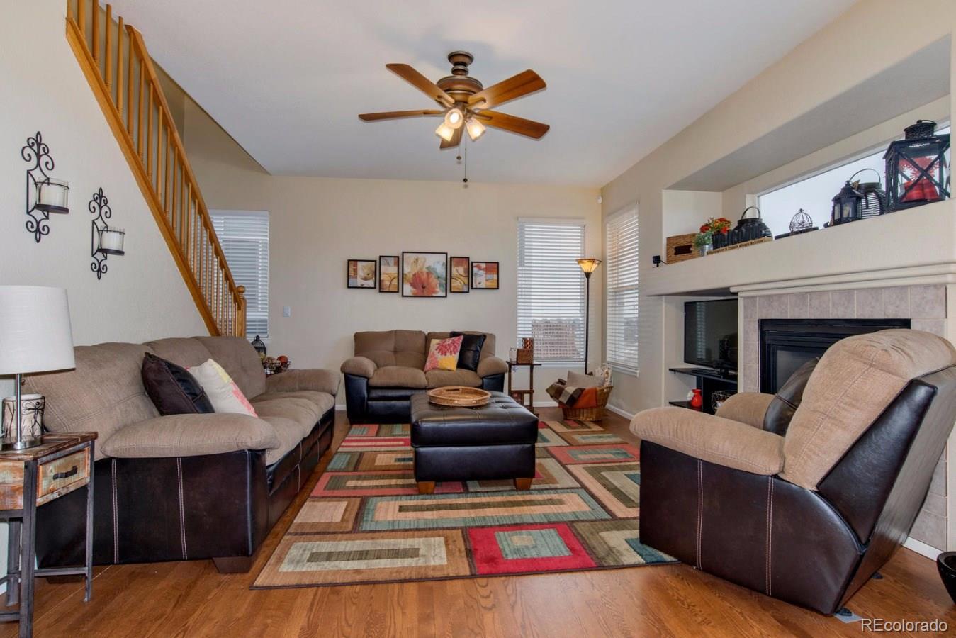 10232 Willowbridge Way Highlands Ranch, CO 80126 - Photo 16 of 33 a living room with furniture and a fireplace