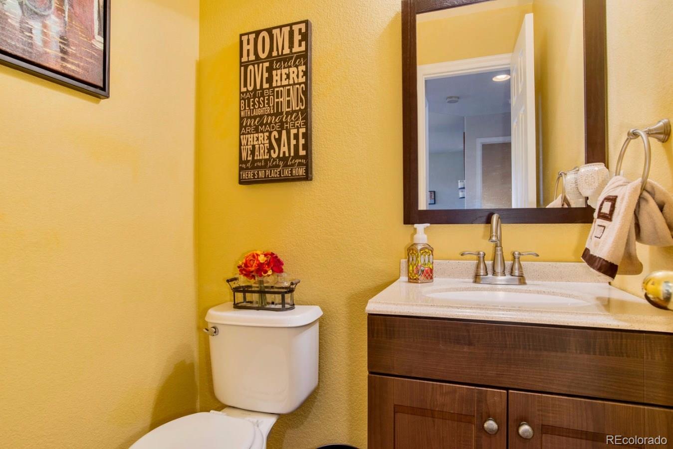 10232 Willowbridge Way Highlands Ranch, CO 80126 - Photo 19 of 33 a bathroom with a sink mirror vanity and toilet