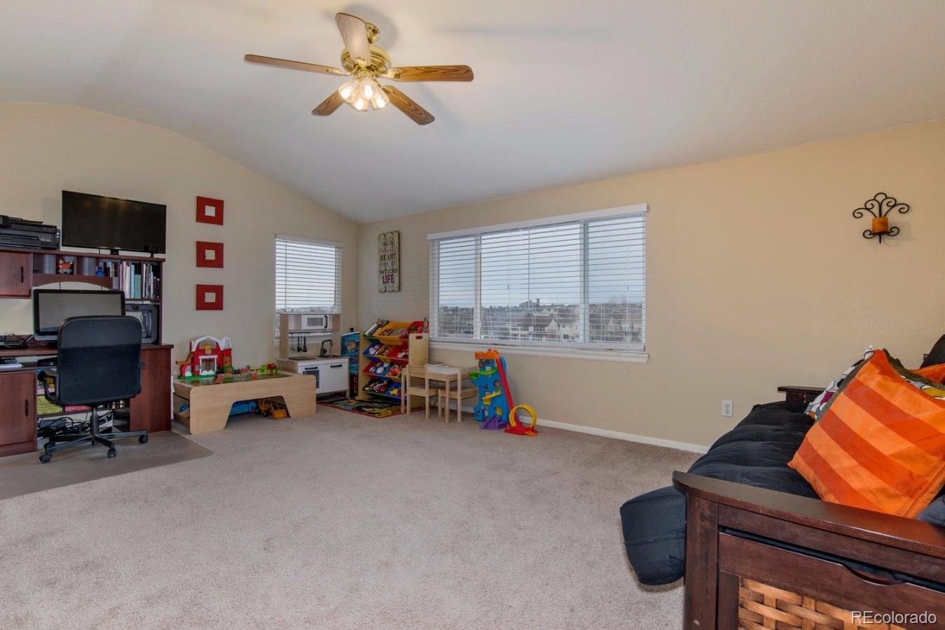 10232 Willowbridge Way Highlands Ranch, CO 80126 - Photo 20 of 33 a living room with furniture and a flat screen tv