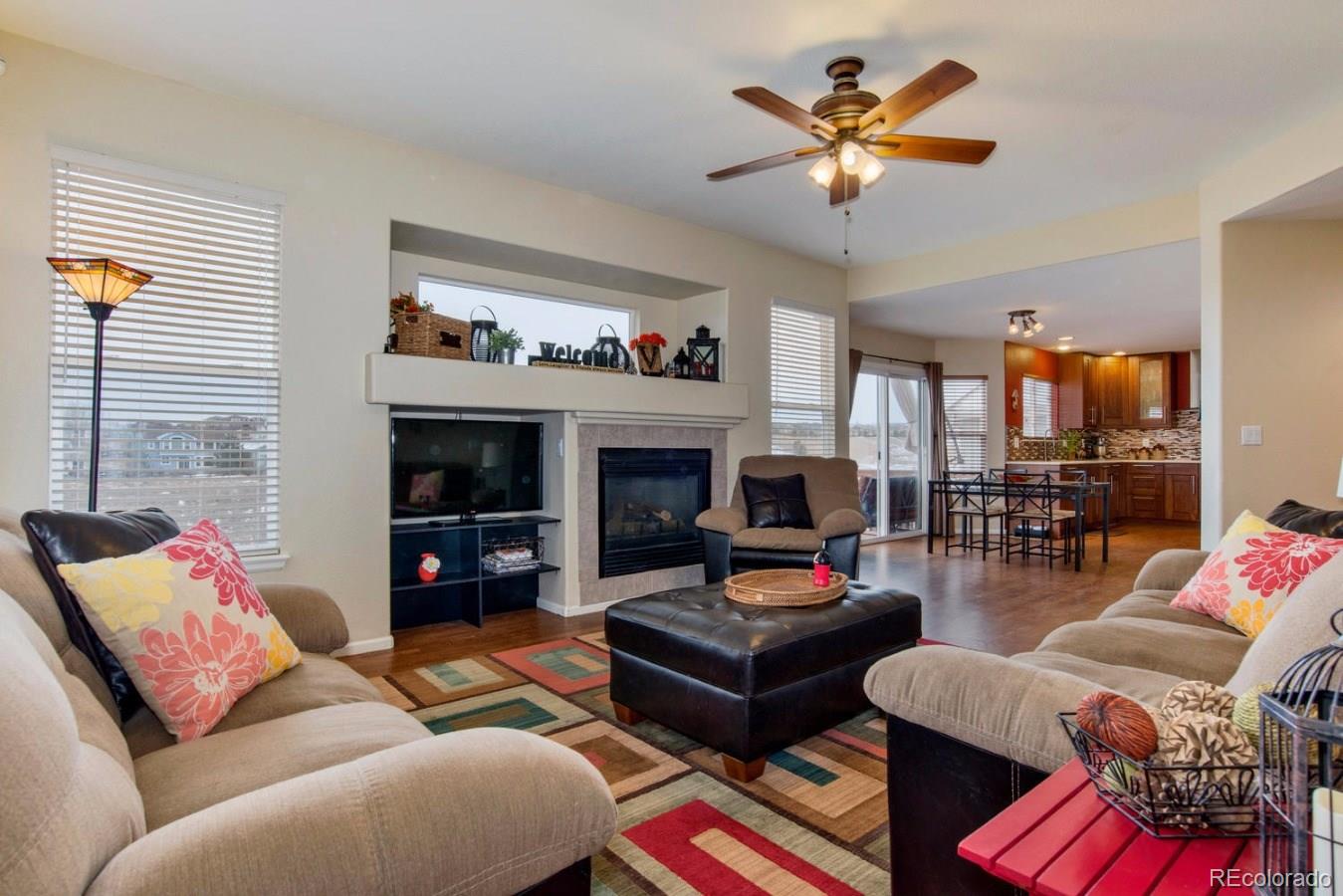 10232 Willowbridge Way Highlands Ranch, CO 80126 - Photo 2 of 33 a living room with furniture fireplace and a flat screen tv
