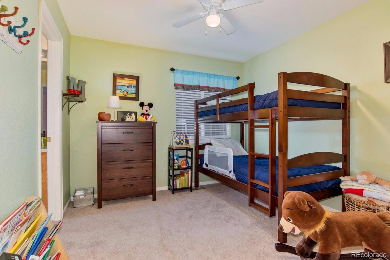 10232 Willowbridge Way Highlands Ranch, CO 80126 - Photo 23 of 33 a bedroom with furniture and a baby crib