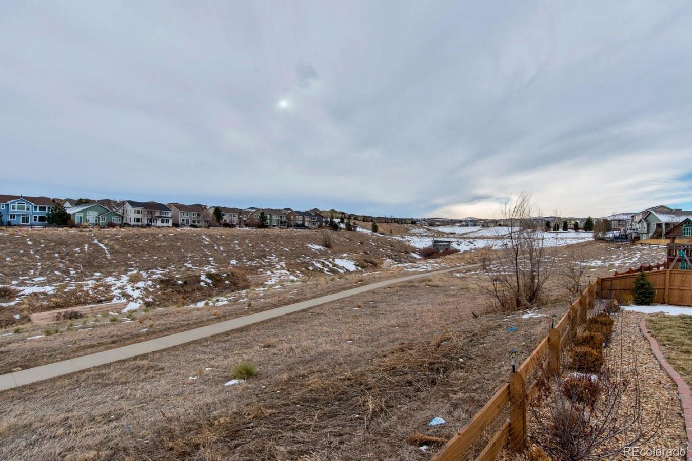 10232 Willowbridge Way Highlands Ranch, CO 80126 - Photo 28 of 33 a view of a lake with a beach