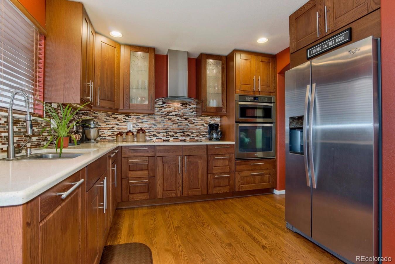 10232 Willowbridge Way Highlands Ranch, CO 80126 - Photo 3 of 33 a kitchen with stainless steel appliances granite countertop a refrigerator and a sink