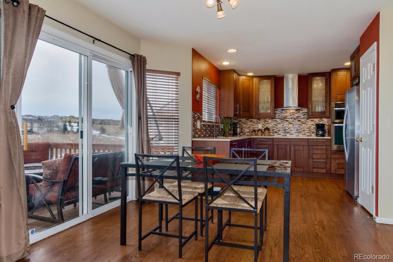 10232 Willowbridge Way Highlands Ranch, CO 80126 - Photo 4 of 33 a view of a kitchen with dining table and chairs