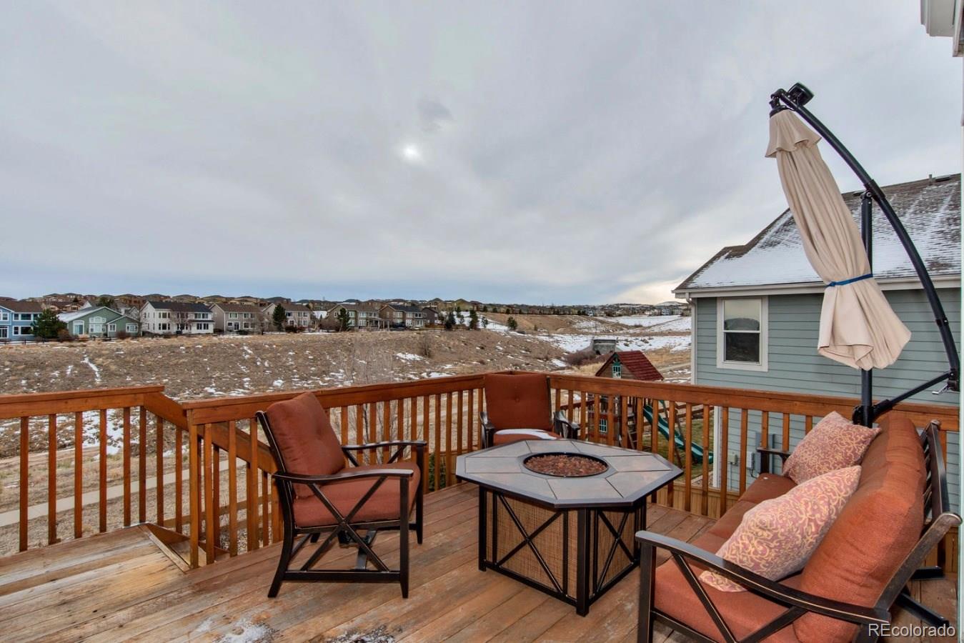 10232 Willowbridge Way Highlands Ranch, CO 80126 - Photo 5 of 33 a view of a chairs and table on the deck
