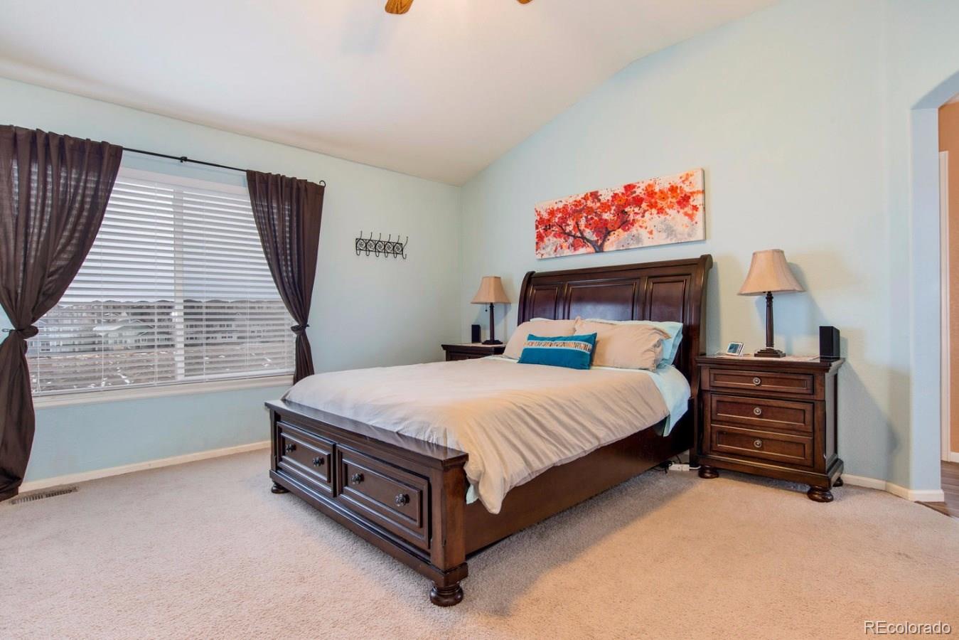 10232 Willowbridge Way Highlands Ranch, CO 80126 - Photo 8 of 33 a bed sitting in a bedroom next to a window