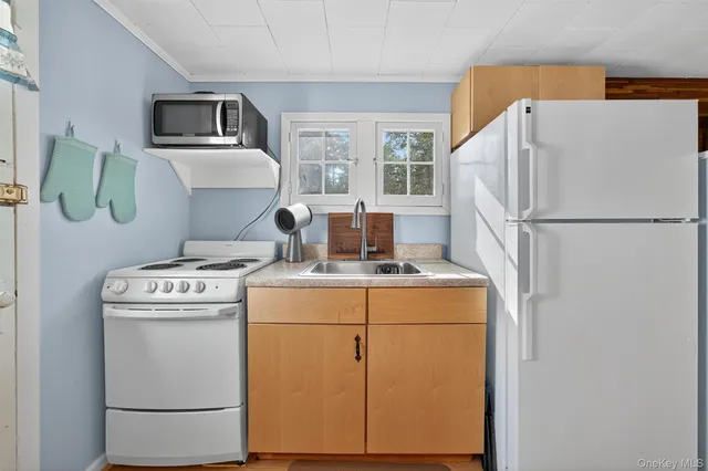 a white house with next to a washer and dryer